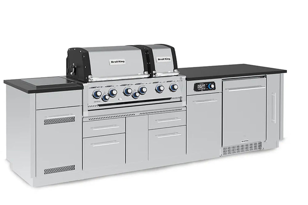 Three-quarter left angle of the Broil King Imperial QS 690iF Smart Grill Island highlighting the side burner station and professional-grade stainless steel storage drawers.