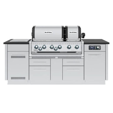 Front view of Broil King Imperial QS 690iE Smart Grill Island with dual stainless steel hoods, black countertops, and closed storage cabinets.