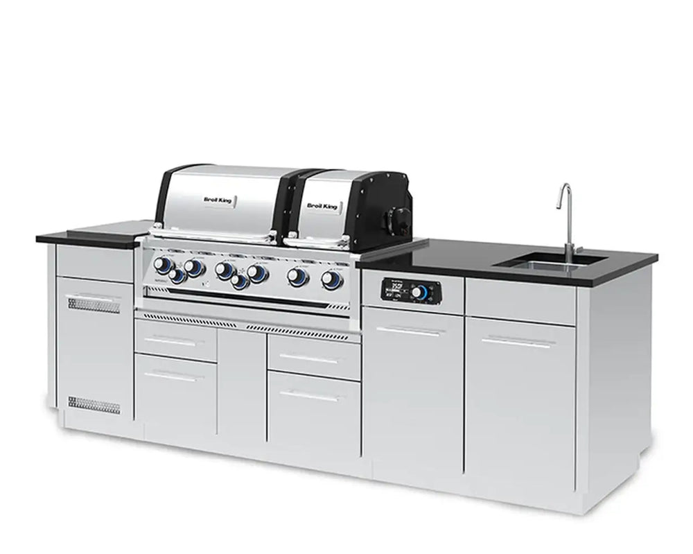 Angled view from the right of the Broil King Imperial QS 690iE smart grill island showing the integrated outdoor sink and spacious preparation countertop.