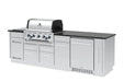 Angled left view of the Broil King Imperial S 590iF grill island, showcasing the integrated side burner, stainless steel cabinetry, and professional-grade rotisserie burner controls.