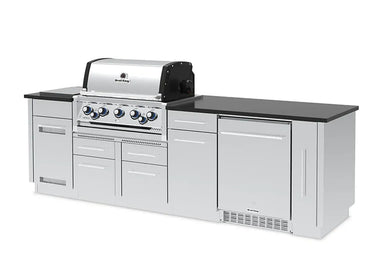 Angled left view of the Broil King Imperial S 590iF grill island, showcasing the integrated side burner, stainless steel cabinetry, and professional-grade rotisserie burner controls.