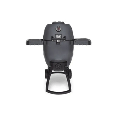 Broil King Keg 5000 kamado charcoal grill with dual side shelves, front thermometer, and wheeled stand on a light gray background.