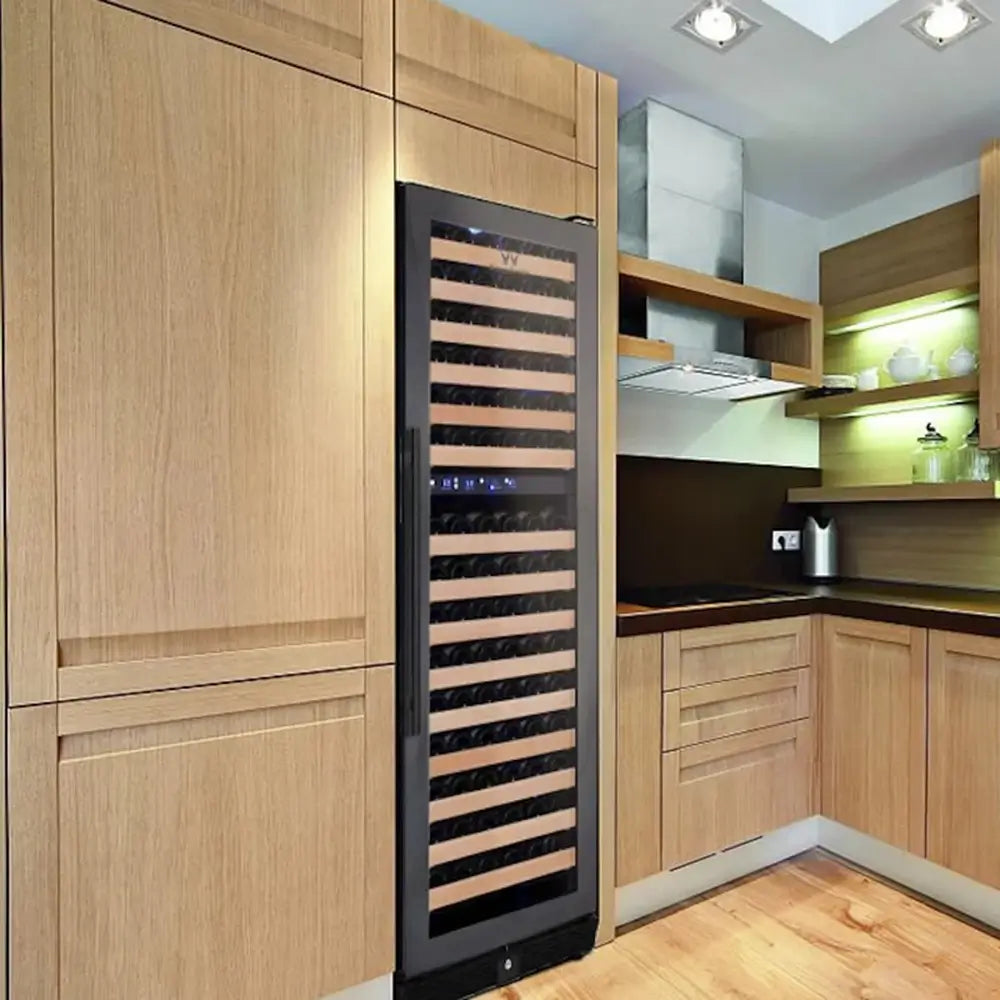 KingsBottle KBU170DX-FG large dual zone wine refrigerator with a seamless borderless glass door built into modern light wood kitchen cabinetry.