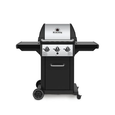 Broil King Monarch 320 freestanding gas grill, front view with three burner control knobs, stainless steel lid, black side shelves, and enclosed cart base
