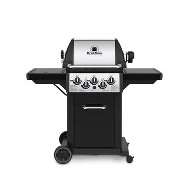 Broil King Monarch 390 gas grill with side burner, front view showing stainless steel lid, three main burner knobs plus side burner controls, black side shelves, enclosed cabinet, and wheeled cart