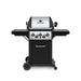 Broil King Monarch 390 gas grill with side burner, front view showing stainless steel lid, three main burner knobs plus side burner controls, black side shelves, enclosed cabinet, and wheeled cart