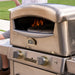 Angled side view of portable pizza oven with foldable legs and built-in gas control knob