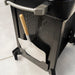 Mounted pizza peel holder with wood handle attached to the side of Blackstone pizza oven stand