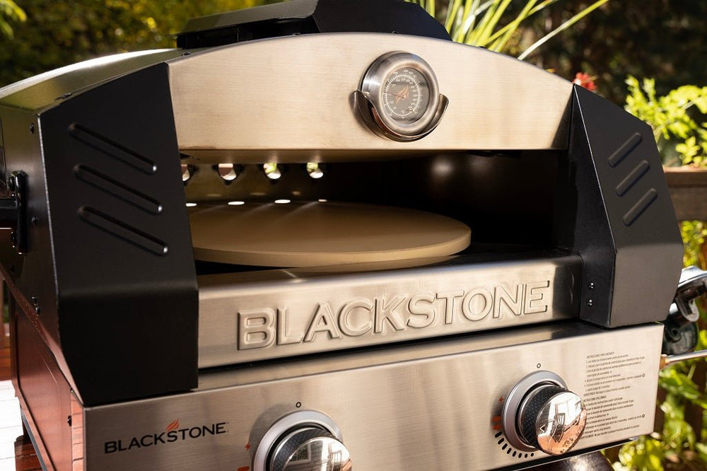 Blackstone tabletop pizza oven interior showing cordierite pizza stone and flame-guarded dome