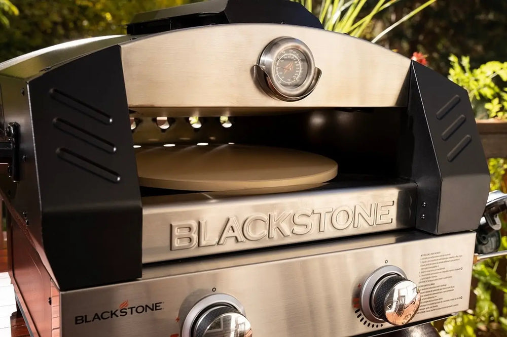 Blackstone tabletop pizza oven interior showing cordierite pizza stone and flame-guarded dome
