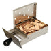 Stainless steel smoker box accessory filled with wood chips for adding smoke flavor to food on the Broilmaster grill