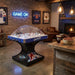 Hathaway Breakaway Dome Hockey table in a rustic-themed basement or living room with exposed brick, leather chairs, and framed hockey jerseys.