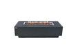 Lit Elementi Granville OFG121DG Fire Table 60" Dark Gray with lava rocks and linear flames on white background.
