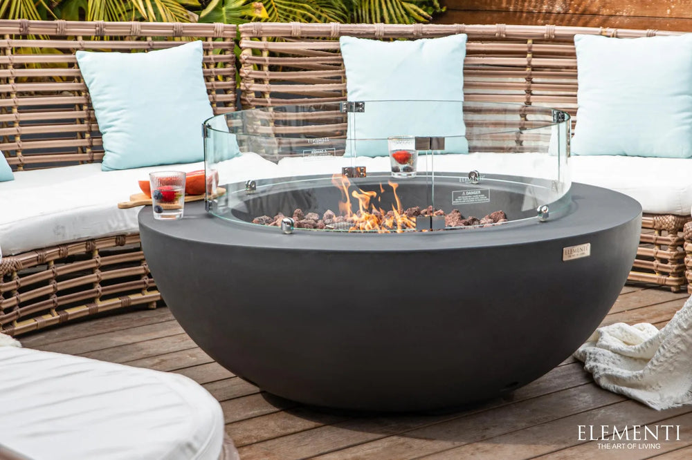 Clear tempered glass circular wind guard installed on an Elementi Lunar Bowl fire pit.