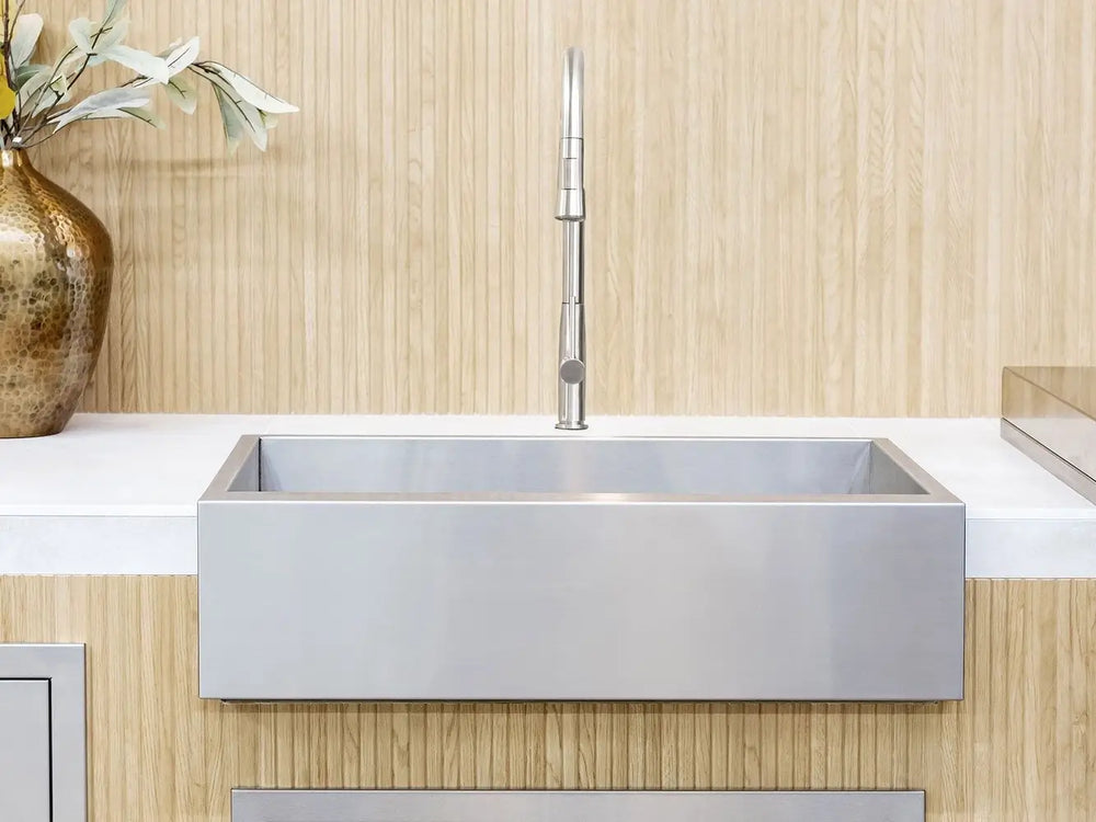 Full front view of Summerset 32" outdoor farmhouse sink and faucet with wood paneling background.