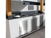 Sunstone 16" stainless trash drawer installed in outdoor kitchen island with sink, storage doors, and stone countertop.