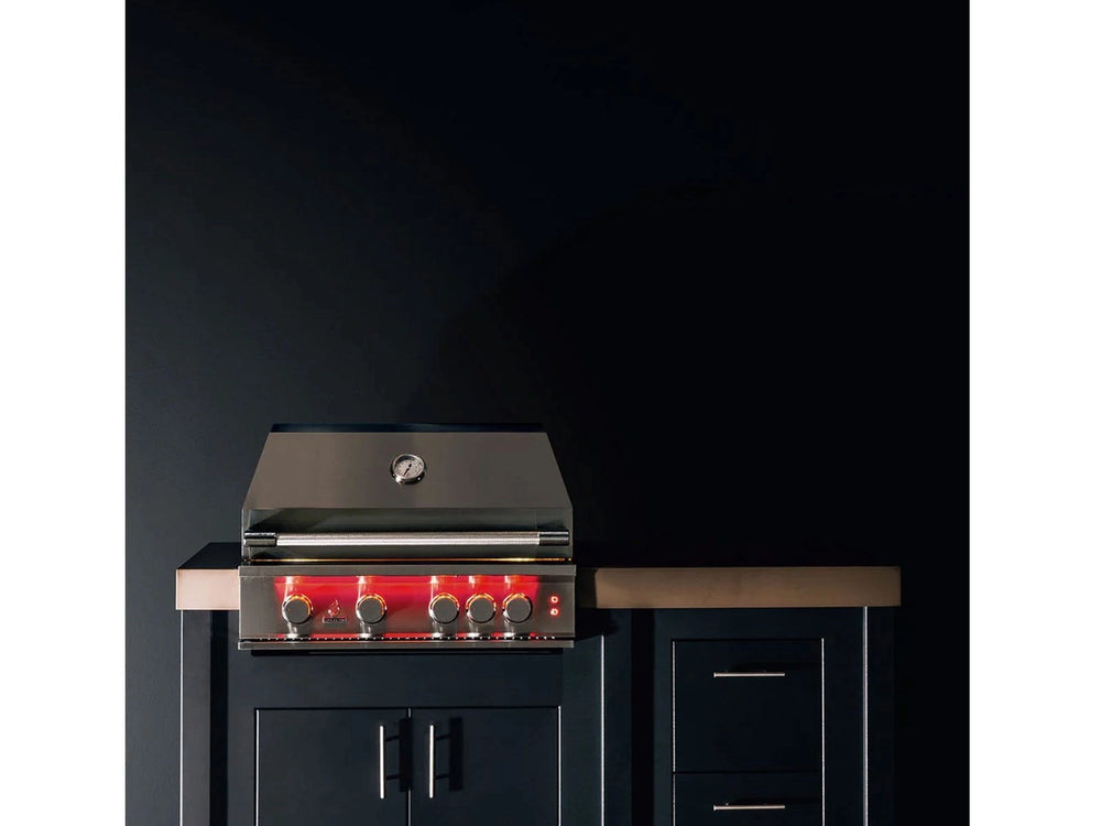 Closed True Flame grill installed in a modern outdoor kitchen, red LED-lit knobs visible against dark cabinetry.