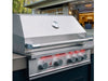Side view of True Flame built-in grill with stainless steel lid closed, red LED-lit knobs glowing beneath control panel.