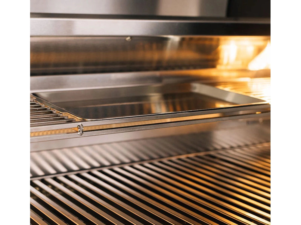 Close-up of warming rack with removable stainless steel tray under halogen lighting inside the True Flame grill.