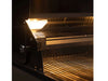 Interior view of grill illuminated by built-in halogen lights, showcasing upper warming rack and stainless steel cooking surface.