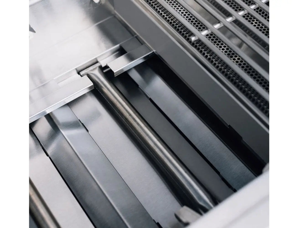 Interior view of True Flame gas grill showing heavy-duty stainless steel U-shaped burner and flame tamers.