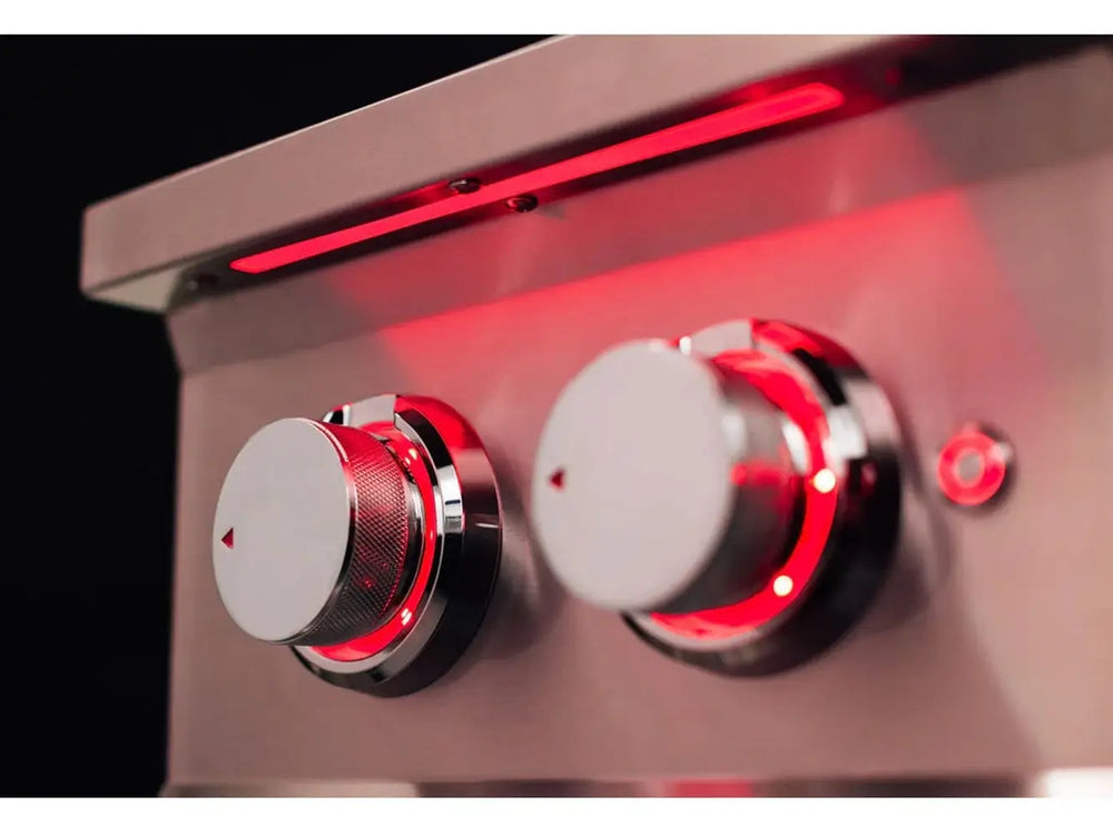 Close-up of True Flame burner control knobs with textured metal finish and vivid red LED backlighting.