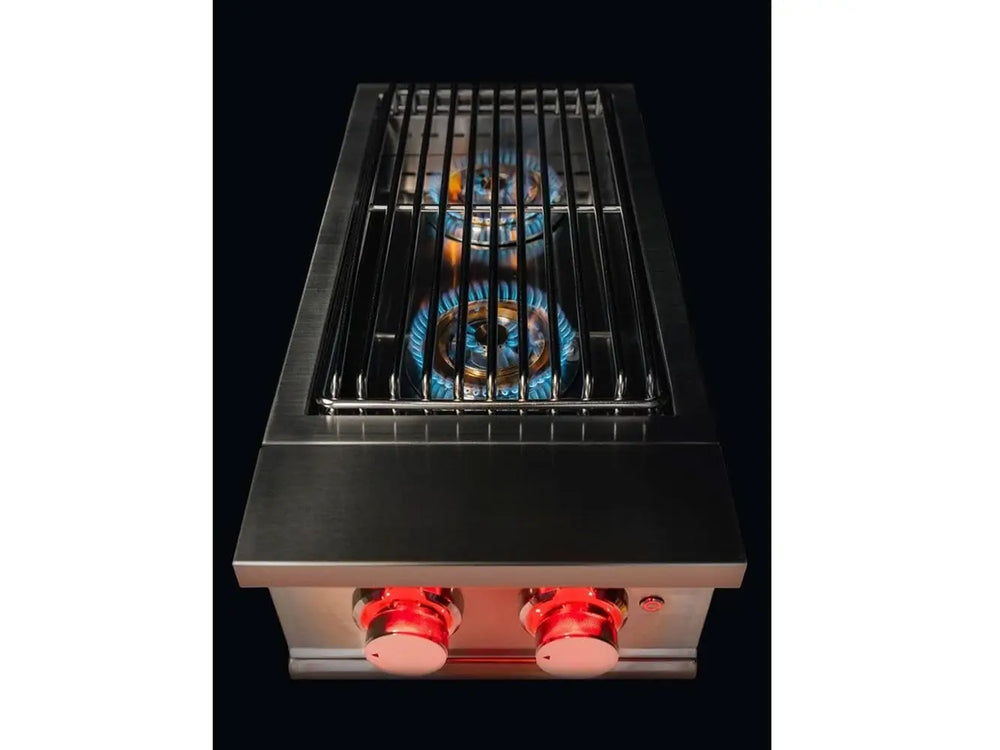 True Flame power burner in operation with blue flames beneath stainless steel grate and red LED-lit knobs.