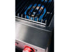 Close-up of blue gas flame on True Flame power burner with illuminated red control knobs.