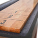 Extreme close-up of a thick wooden shuffleboard playfield showing the scoring zones marked 1, 2, and 3, surrounded by gray gutter felt.