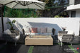 Modern patio setting featuring the Colorado sunlight yellow rectangular fire pit table as a centerpiece, paired with designer seating and a classic silver trailer in the background.